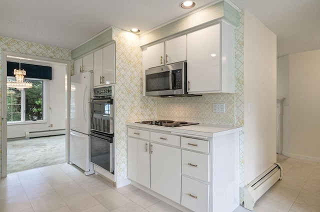 27 Fuller Pond Rd Unit 27, Middleton, MA 01949 - kitchen featuring baseboard heating, black appliances, light countertops, a chandelier, and baseboards