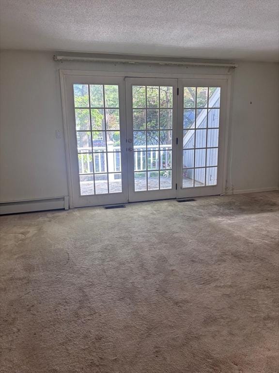 27 Fuller Pond Rd Unit 27, Middleton, MA 01949 - doorway to outside featuring baseboard heating, a textured ceiling, healthy amount of natural light, and carpet floors