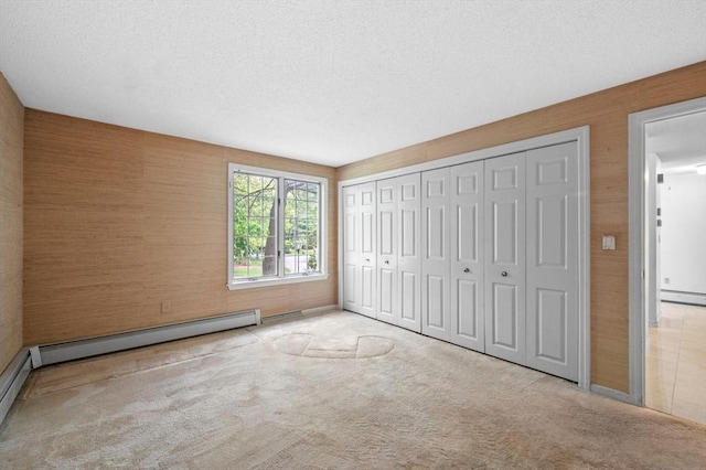 27 Fuller Pond Rd Unit 27, Middleton, MA 01949 - unfurnished bedroom with carpet flooring, a textured ceiling, a closet, baseboard heating, and a baseboard heating unit