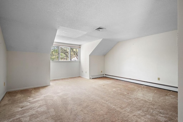 27 Fuller Pond Rd Unit 27, Middleton, MA 01949 - bonus room featuring carpet, baseboard heating, a textured ceiling, vaulted ceiling, and baseboards