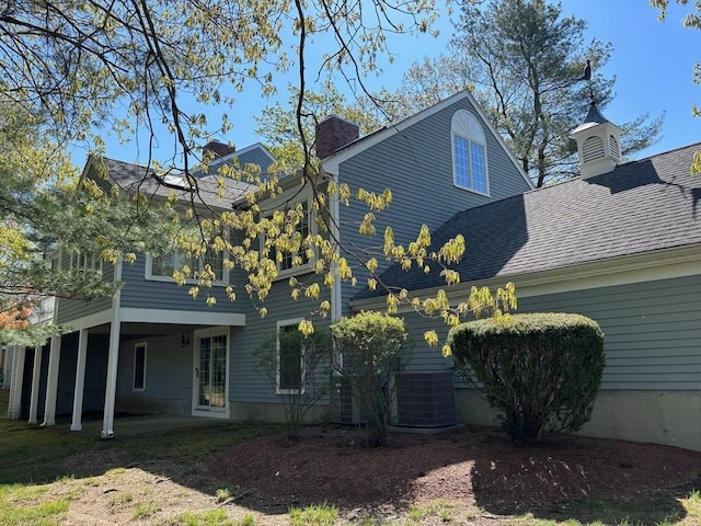 27 Fuller Pond Rd Unit 27, Middleton, MA 01949 - view of side of home with a chimney, a patio area, and roof with shingles