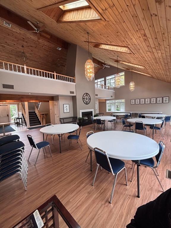 27 Fuller Pond Rd Unit 27, Middleton, MA 01949 - dining room featuring high vaulted ceiling, a ceiling fan, wood finished floors, wood ceiling, and a fireplace