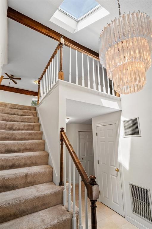 27 Fuller Pond Rd Unit 27, Middleton, MA 01949 - stairs with a towering ceiling, tile patterned flooring, a skylight, and a ceiling fan