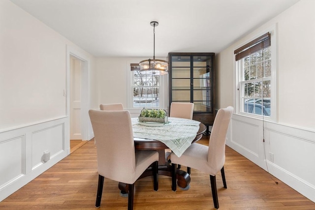 dining area with a chandelier and light wood-type flooring