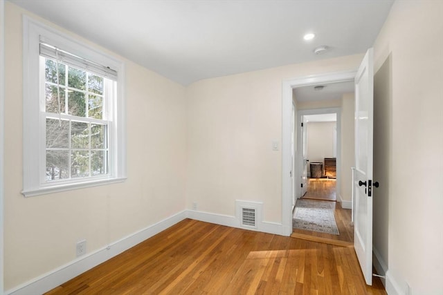 spare room featuring wood-type flooring