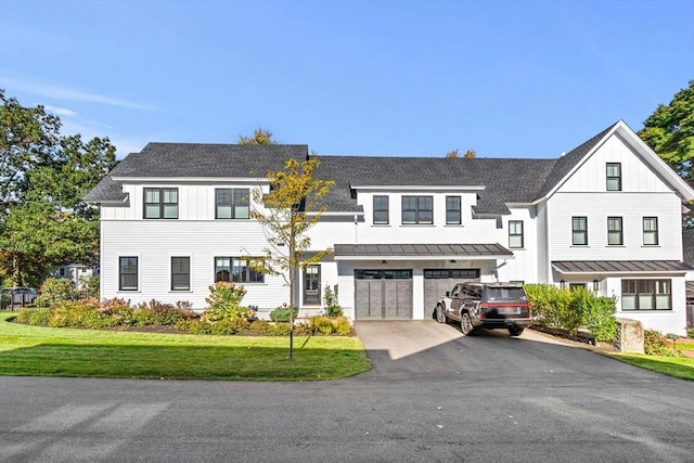 modern farmhouse style home with a garage and a front yard