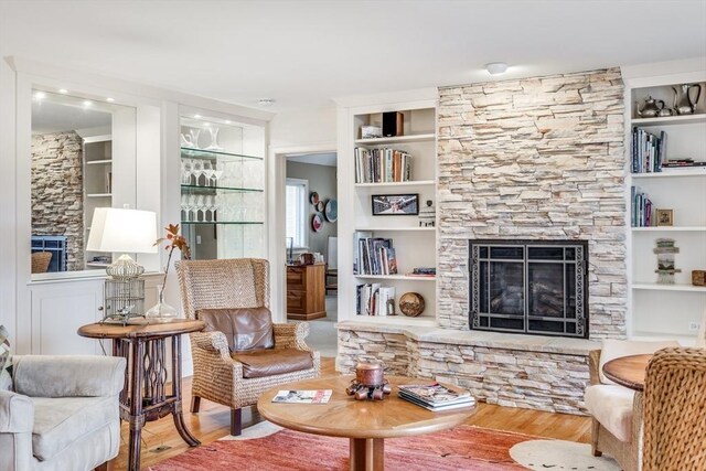 39 Fairway Pointe Rd Unit 39, Falmouth, MA 02536 - living room featuring a fireplace, built in features, and wood finished floors