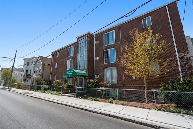 124 Addison St Unit 15, Chelsea, MA 02150 - view of building exterior featuring a fenced front yard