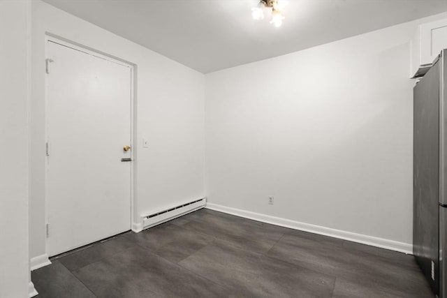 124 Addison St Unit 15, Chelsea, MA 02150 - unfurnished room featuring baseboards, a baseboard radiator, and concrete floors