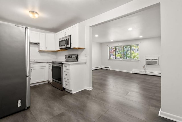 124 Addison St Unit 15, Chelsea, MA 02150 - kitchen with white cabinets, stainless steel appliances, baseboards, a baseboard radiator, and a wall mounted AC