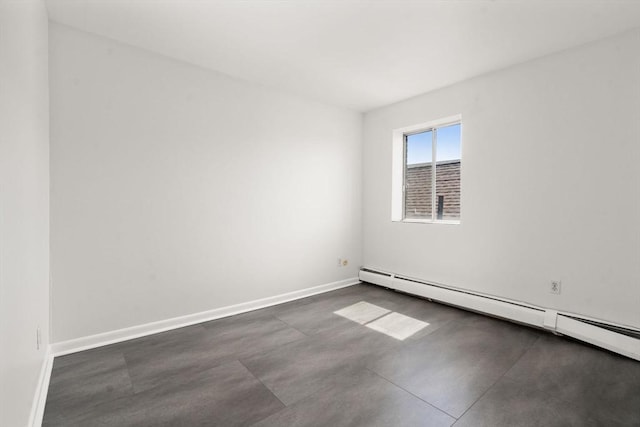 124 Addison St Unit 15, Chelsea, MA 02150 - empty room featuring baseboards, a baseboard heating unit, and finished concrete flooring