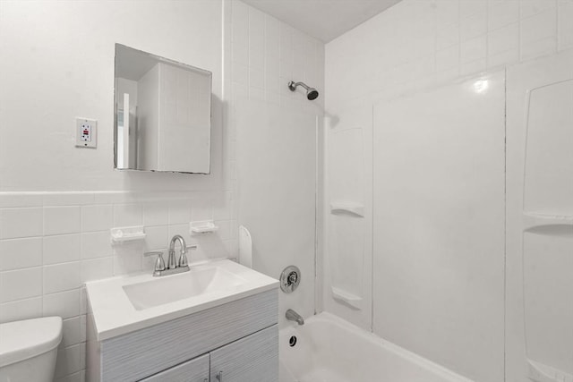 124 Addison St Unit 15, Chelsea, MA 02150 - bathroom with tile walls, washtub / shower combination, vanity, and toilet
