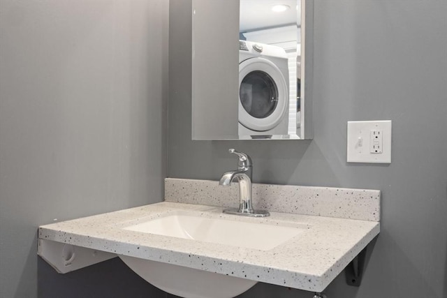 bathroom with vanity and stacked washer / drying machine