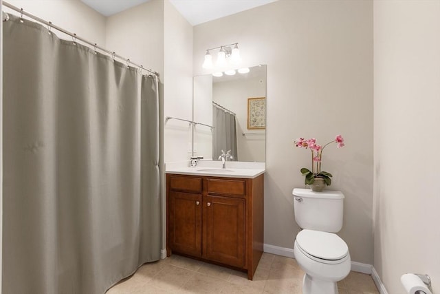 bathroom featuring vanity, tile patterned floors, and toilet