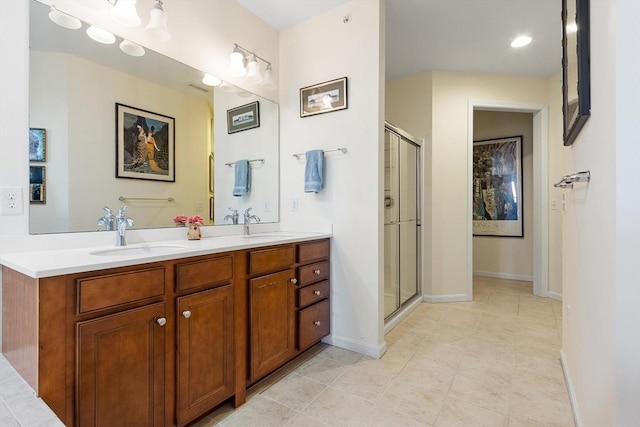 bathroom with tile patterned flooring, a shower with door, and vanity