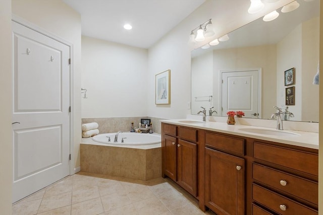 bathroom with vanity, tile patterned floors, and a relaxing tiled tub