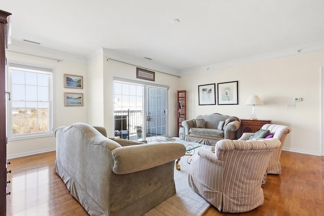 living room featuring light hardwood / wood-style floors and crown molding