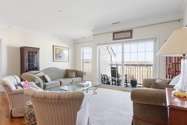 living room with light wood-type flooring and crown molding