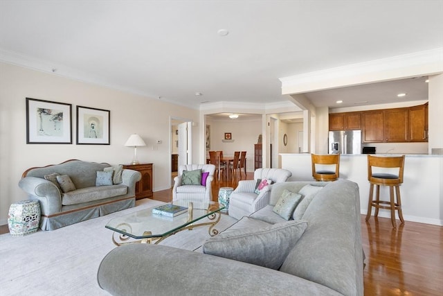 living room featuring ornamental molding and dark hardwood / wood-style floors