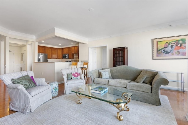 living room featuring light hardwood / wood-style flooring and crown molding