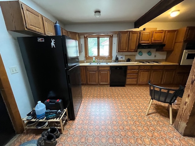 kitchen with beam ceiling, black appliances, and sink