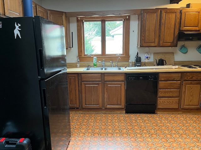 kitchen featuring range hood, black appliances, and sink