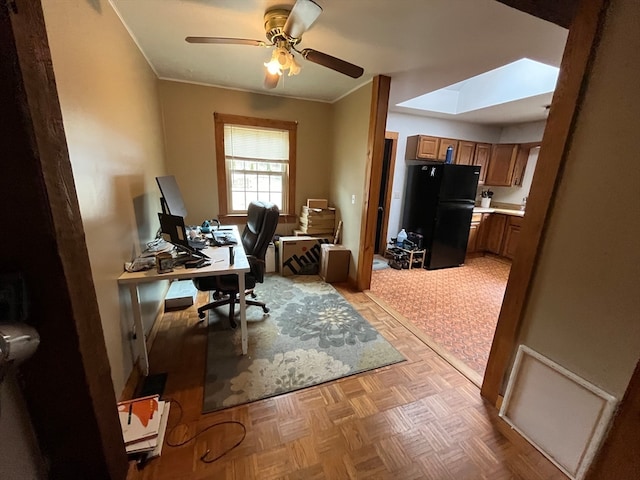 home office with ornamental molding, a skylight, light parquet floors, and ceiling fan