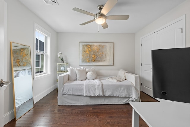 bedroom with dark hardwood / wood-style floors and ceiling fan