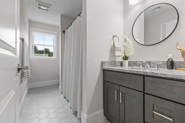 bathroom featuring tile patterned flooring and vanity