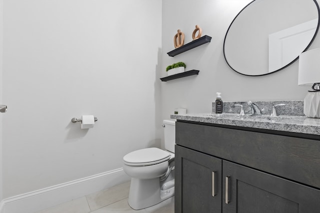 bathroom featuring tile patterned flooring, vanity, and toilet