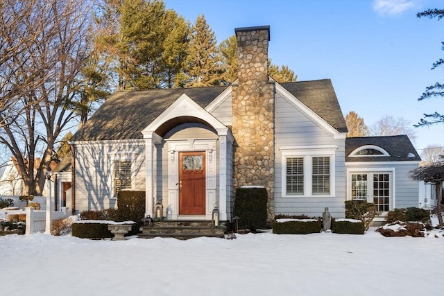 view of front of home featuring roof with shingles and a chimney