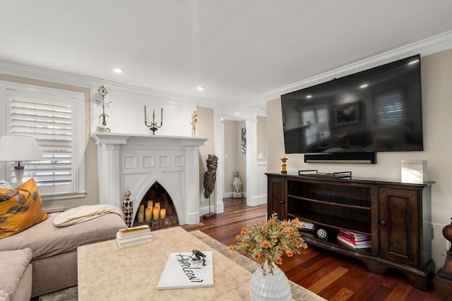 living area with baseboards, dark wood finished floors, a fireplace with flush hearth, ornamental molding, and recessed lighting