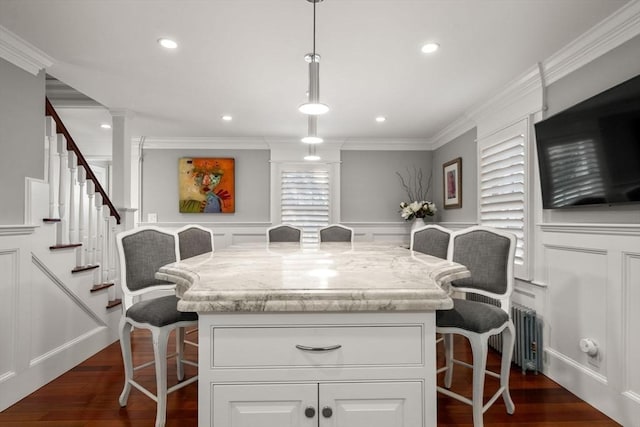 kitchen with a decorative wall, a kitchen bar, and dark wood-style flooring