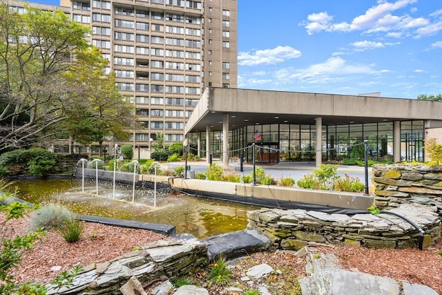 view of property's community with a small pond