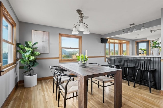 63 Seaside Rd, Scituate, MA 02066 - dining area featuring a dry bar, baseboards, and light wood finished floors