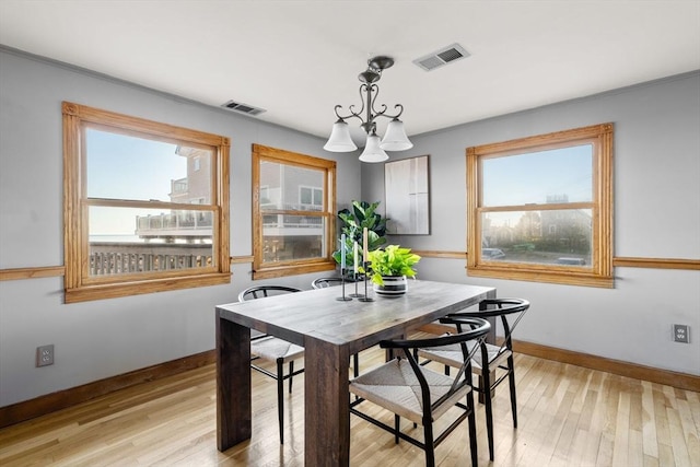 63 Seaside Rd, Scituate, MA 02066 - dining room with baseboards, light wood-type flooring, a chandelier, and ornamental molding