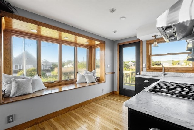 63 Seaside Rd, Scituate, MA 02066 - kitchen featuring ventilation hood, baseboards, a sink, light wood-style floors, and stainless steel gas stovetop