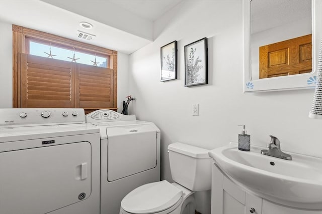 63 Seaside Rd, Scituate, MA 02066 - bathroom with washer and clothes dryer, toilet, and vanity