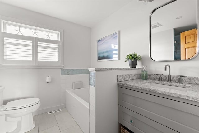 63 Seaside Rd, Scituate, MA 02066 - bathroom featuring tile patterned floors, vanity, toilet, and a garden tub