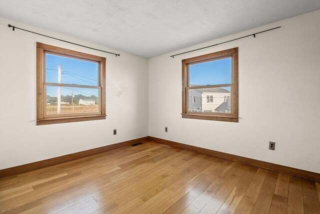 63 Seaside Rd, Scituate, MA 02066 - unfurnished room featuring baseboards, healthy amount of natural light, and light wood-style flooring