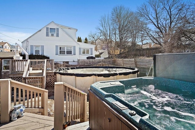 exterior space featuring fence and a hot tub