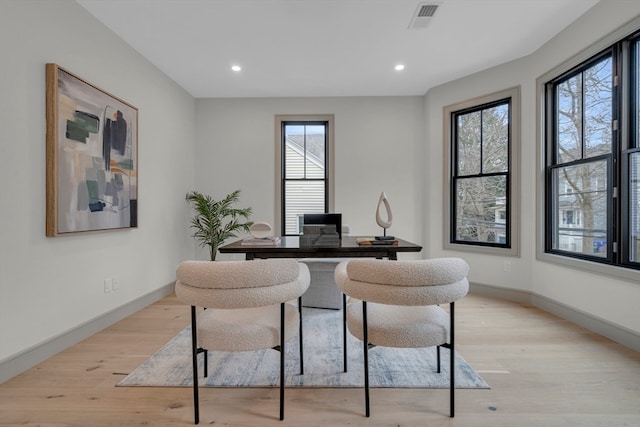 office space featuring light wood-type flooring and a wealth of natural light