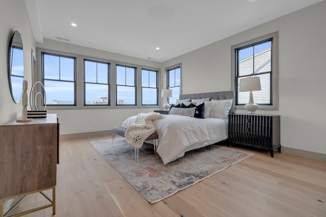 bedroom featuring light wood-type flooring and radiator heating unit