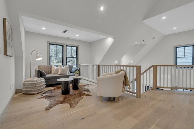 sitting room with vaulted ceiling and light hardwood / wood-style flooring