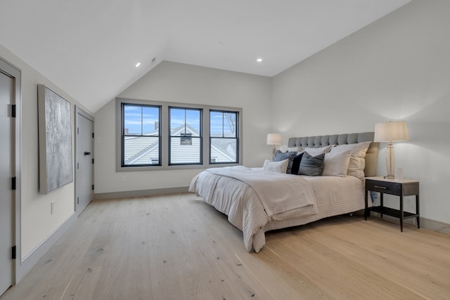 bedroom with light hardwood / wood-style flooring and vaulted ceiling