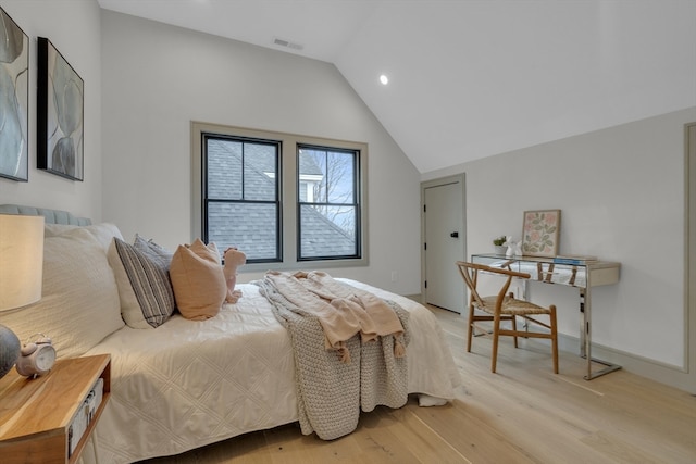 bedroom featuring light hardwood / wood-style floors and vaulted ceiling