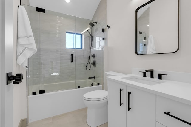 full bathroom with vanity, toilet, bath / shower combo with glass door, and vaulted ceiling