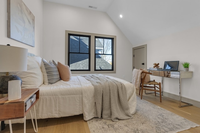 bedroom featuring hardwood / wood-style floors and lofted ceiling