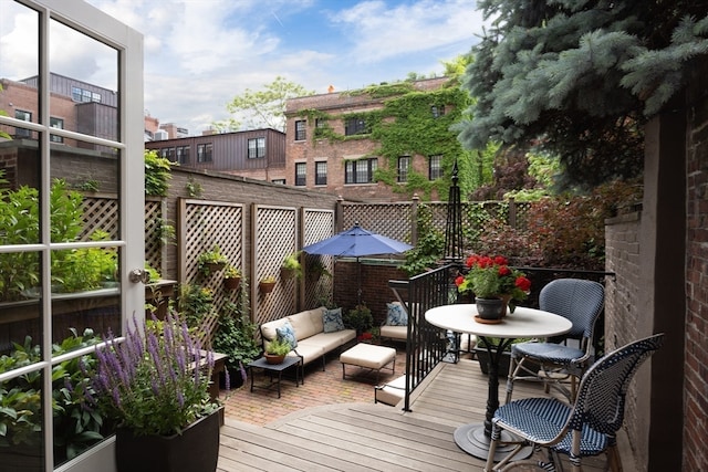 wooden balcony featuring outdoor lounge area and a deck