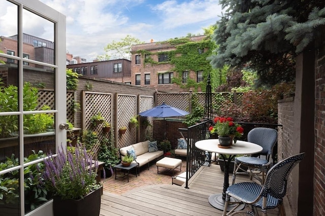 view of wooden balcony featuring an outdoor hangout area and a wooden deck